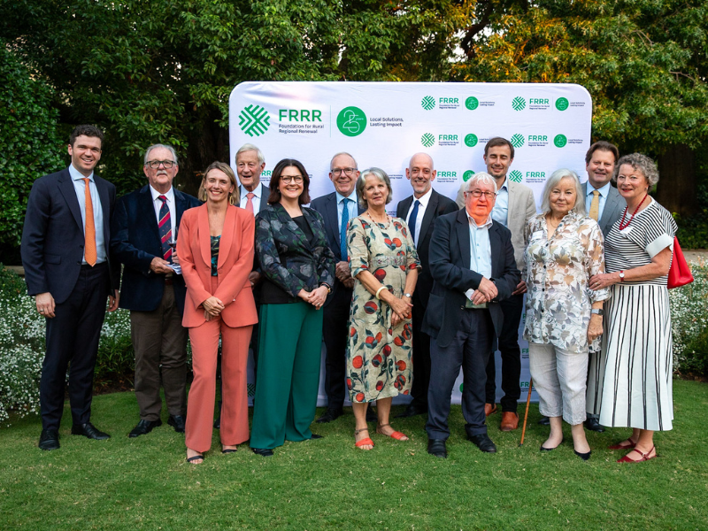 Image of group of people dressed formally posing.