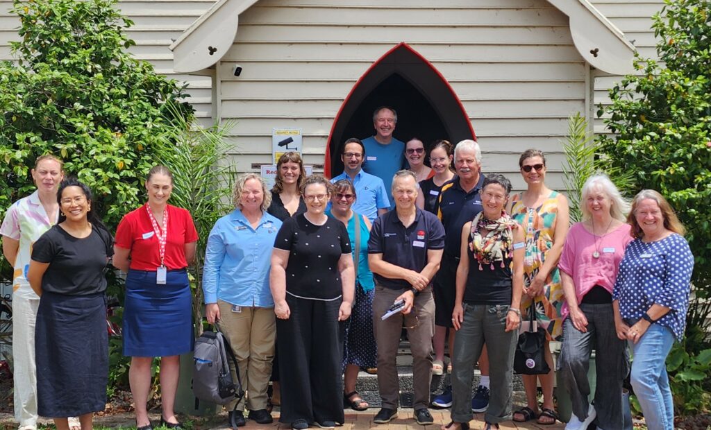 A group of people standing at the entrance of a building that has an arch.