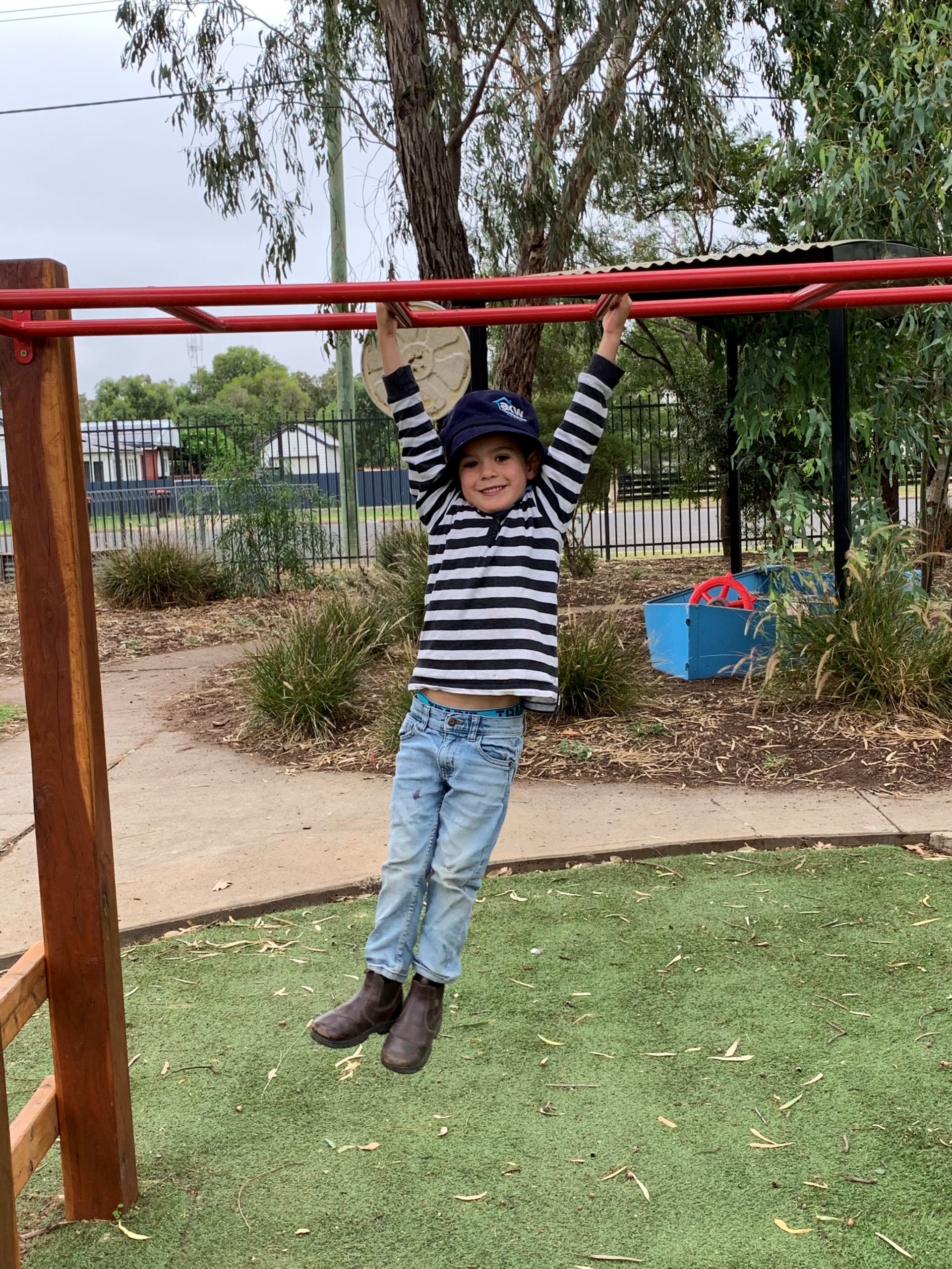 HEADING: Nutrien grant provides improved facilities for children’s occupational therapy. IMAGE: Child on the monkey bars looking at the camera.