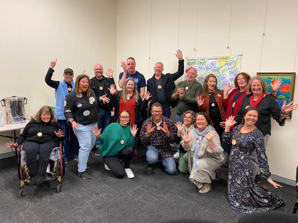 A group of people cheering, some with their arms in the air.