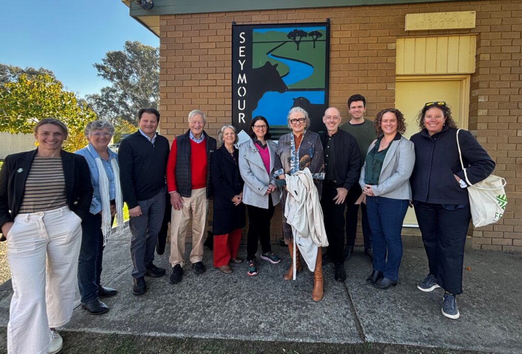 Group of people standing in semi circle.