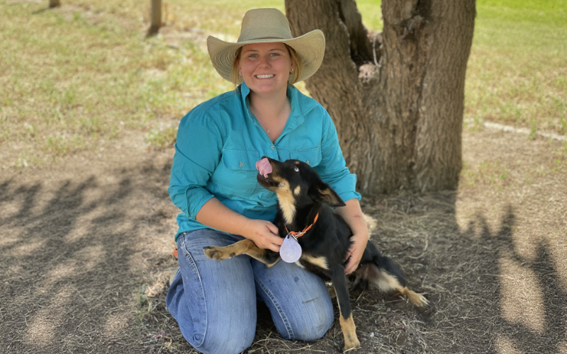 Young rural woman with working dog