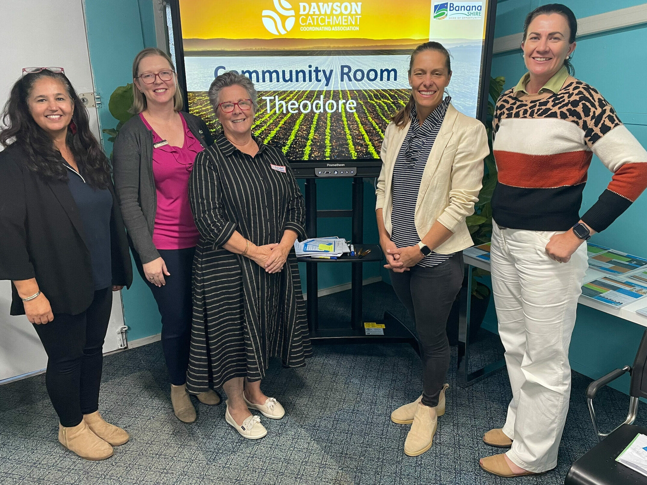Group of people standing in front of a banner