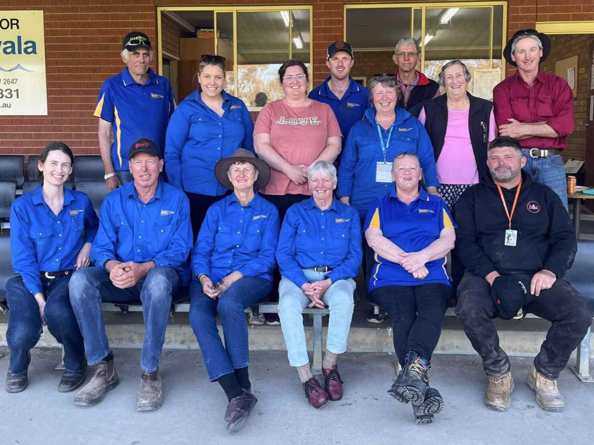 Group of people wearing new blue uniforms. 