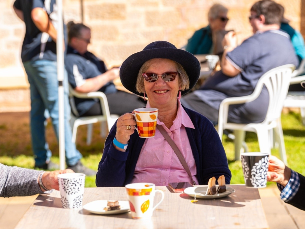 Women sitting on a chair having a cup of tea