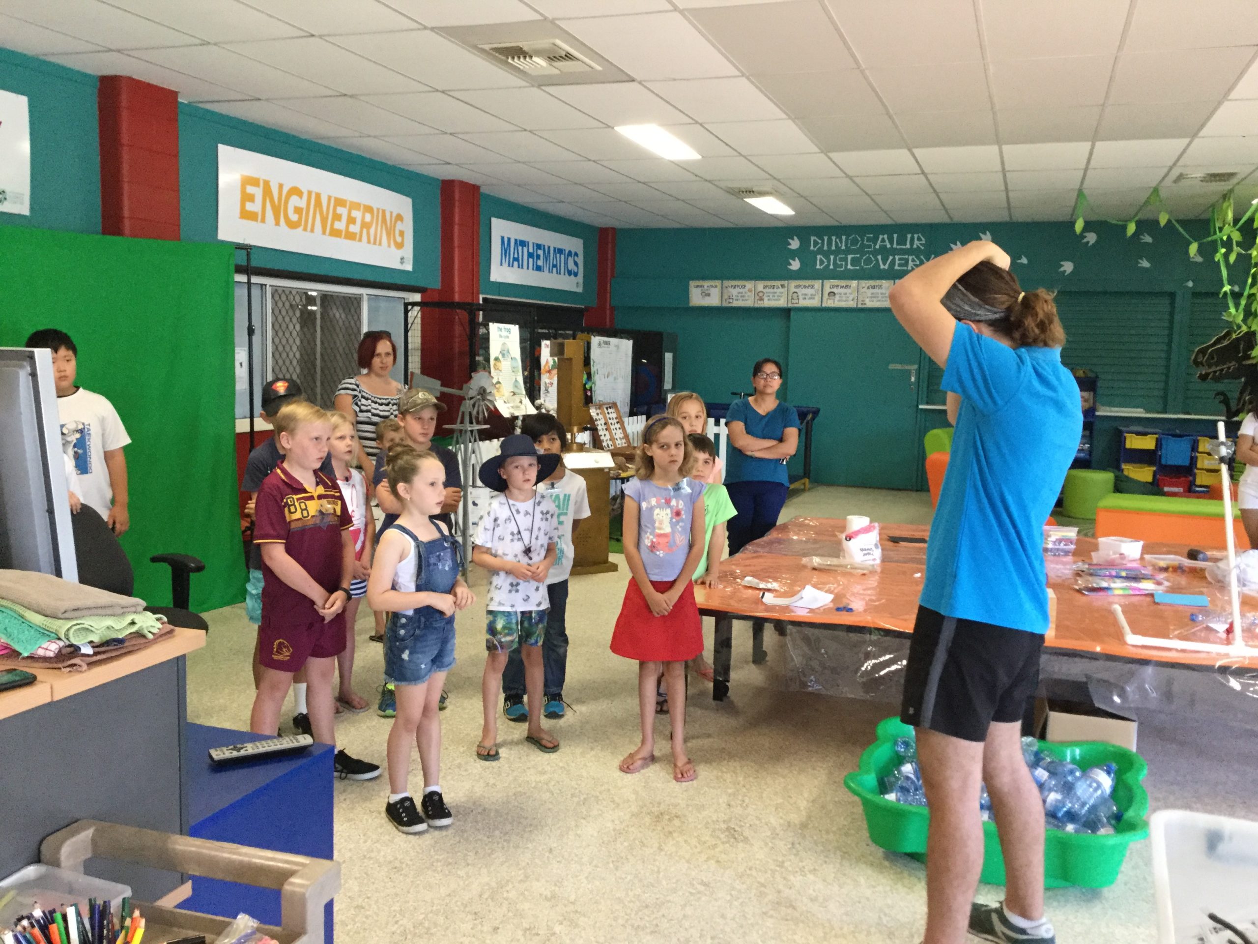 Students in a classroom with their teacher learning about science.