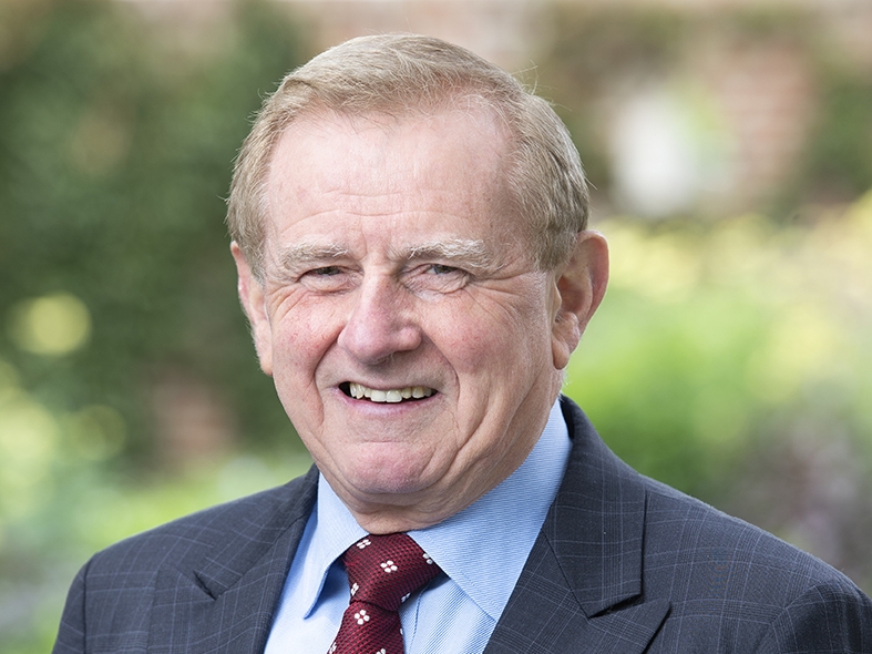 Picture is the report cover which features a person wearing a beautiful dress and a headpiece. There is a pink tint over the image Hon Simon Crean