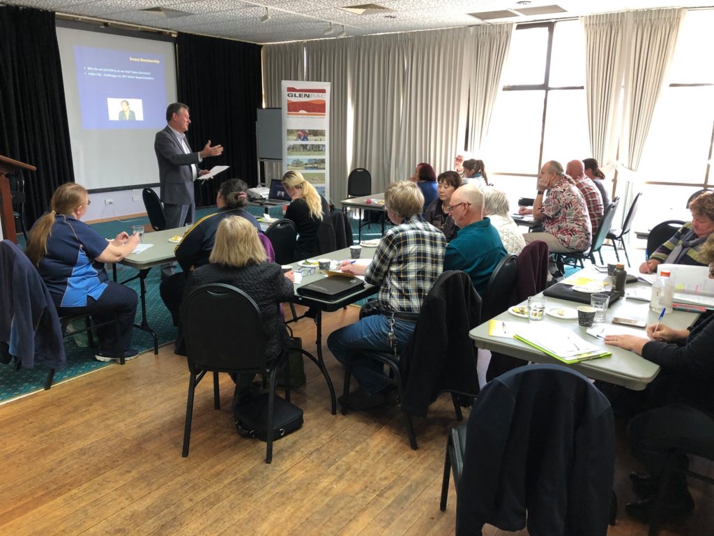 HEADING: Good governance supports great outcomes in Glen Innes. IMAGE: Group of people sitting in on a presentation.