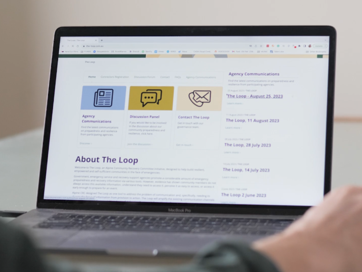 Image of a laptop screen displaying The Loop homepage. 