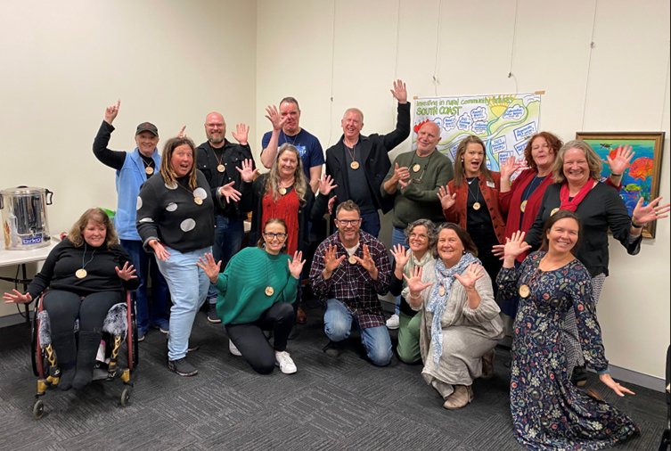 A group of happy people celebrating with jazz hands.