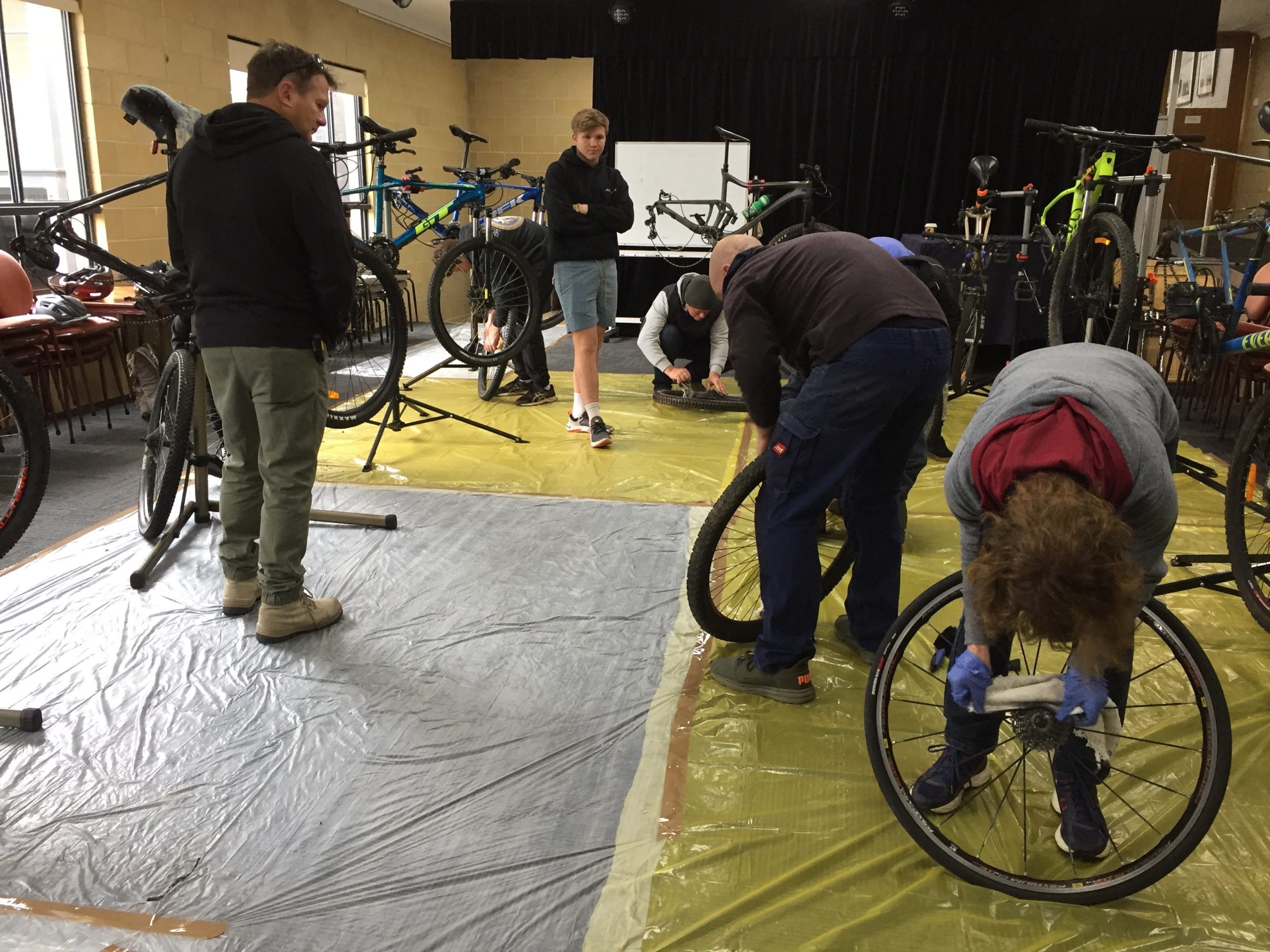 A group of people working on bicycles