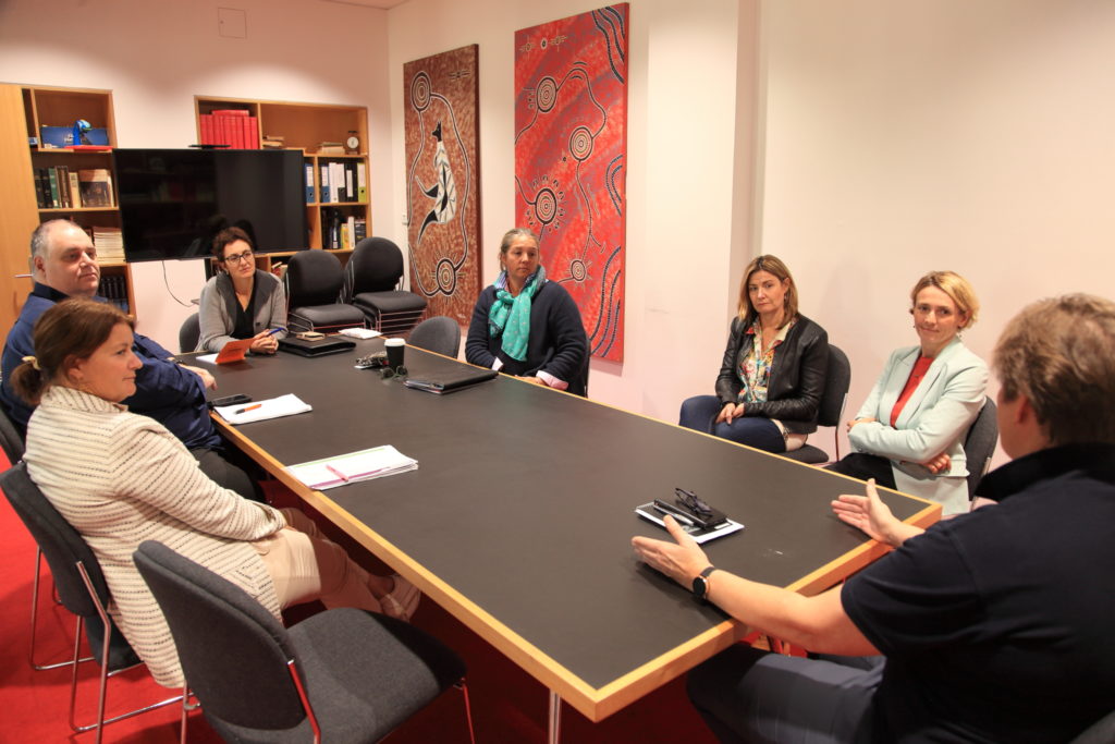 FRRR and donor partners hearing directly from community leaders, sitting around a table chatting.